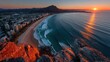 © Darminah - Sunrise over city beach. Coastal cityscape at dawn
