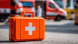 © Екатерина Чумаченко - First aid kit in front of emergency vehicles. Ready for medical assistance and help during critical situations. Healthcare and safety concept.