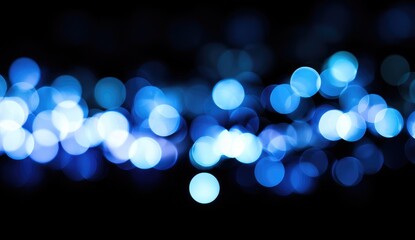 Abstract bokeh lights in shades of blue on a black background