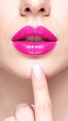 © bestimagestock - A woman with vibrant pink lipstick gently rests her finger on her lips, exuding a playful yet mysterious allure, set against a soft, blurred background.