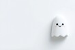 © Oksana Smyshliaeva - Cute Smiling Ghost on Minimal White Background for Halloween Decor.