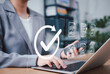 © Sandwish - Document Approval and Quality Assurance Process Concept. A professional working on laptop with icons of documents and check mark, symbolizing document validation, compliance, and approval workflow.