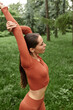 © Bliss - Elegant yoga teacher demonstrating flexibility in a serene outdoor setting during morning practice