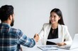 © Lamaba - Business meeting handshake: successful job interview with asian woman in white blazer suit