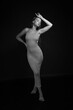 © Сергей Луговский - Black and white low key portrait of slender young barefoot woman in dress full length
