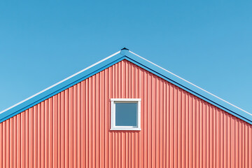 Poster - Minimalist architectural shot of a salmon-colored building with a white window under a clear blue sky, capturing a sense of serenity and modern design.