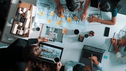 Poster - Top aerial view business people brainstorming about building interior at table with house model and laptop displayed house plan while architect engineer drawing and writing at blueprint. Alimentation.