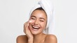 © Katsiaryna - Young woman enjoying skincare routine at home with a cheerful smile