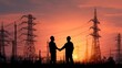 © EKAN KUDAH - Sunset energy deal engineers shake hands at power plant