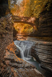 Waterfall flows under a stone bridge in Watkins Glen State Park in New York
