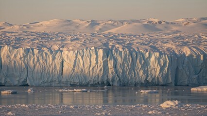 Wall Mural - snow-covered glacier and icy lake illuminated by sun in extreme cold environment