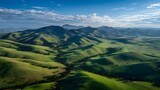Rolling green hills covered soft grass under a clear sky with midday sunlight birds eye view capturing expansive open fields and farmlands pure natural lighting no artificial effects