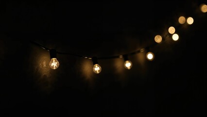 Wall Mural - glowing blurred light bulb garland for festive overlays