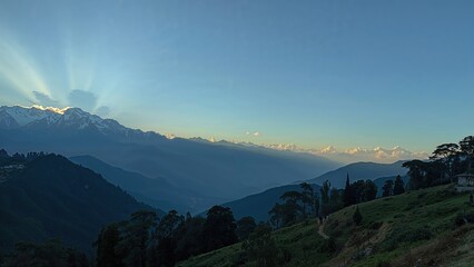 Wall Mural - breathtaking sunrays shining on mountain terrain