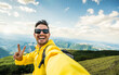 © Davide Angelini - Young hiker man taking selfie portrait on the top of mountain - Happy guy smiling at camera - Hiking, sport, travel and technology concept - Bright filter