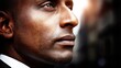 © PaulShlykov - Close-up of a confident man with dark skin and short hair looking into the distance
