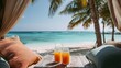 © Alex Photography - Two glasses of orange juice on a table, with palm trees and a serene turquoise ocean in the background.
