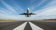 © Muzaki - Passenger airplane taking off from an airport runway. Low angle front view of a commercial jet against a blue sky.
