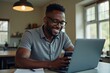 © Vera - African American Man Updating Software on His Mobile Phone and Laptop