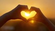 © WS Studio 1985 - Love's Golden Embrace: Two hands, forming a heart shape, frame the warm glow of the setting sun, symbolizing love, warmth, and the beauty of connection.