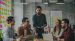 © taqi - Diverse professionals collaborate in a modern office brainstorming innovative ideas and strategies