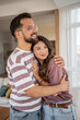 © Migma_Agency - Happy couple embracing tenderly in living room