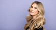 © Zayla Studio - Portrait of a woman with long blonde wavy hair posing against a light purple colored background