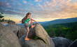 © bilanol - Young woman climbing alone on rocky mountain path. Female hiker enjoying difficult challenge on wilderness trail. Active way of life concept