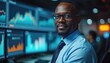 © Pete - Kenyan male Forex trader smiles confidently in front of multiple screens displaying financial market graphs. Professional businessman in Nairobi analyzes currency trading data, charts, growth