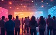 © คงเดช ผาผง - A crowd of people is watching a large screen at a conference or event, bathed in vibrant colorful lights that create an immersive experience for the ence.