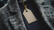 © Suphawan - Blank clothing tag mockup clipped to a stylish coat, perfect for elegant or luxury brand identity use