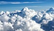 © Tan - Aerial view of fluffy cumulus cloudscape, bright blue sky above