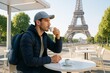 © Who is Danny - Young man drinking coffee at outdoor cafe with Eiffel Tower in background on a sunny day, concept of solo travel and peaceful moment in light setting. Ai generative