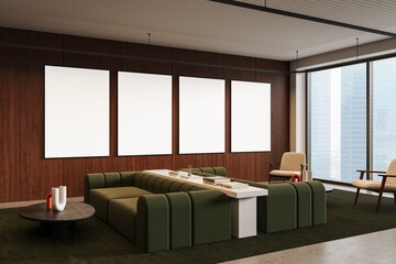 Poster - Modern office interior with four blank posters on wooden wall above stylish green sofa and white table in cozy lounge area with city view windows. 3D Rendering