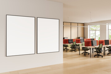 Poster - Empty poster mockup frames on clean wall inside modern open office interior with red desk dividers and wood flooring in natural daylight setting. 3D Rendering