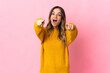 © luismolinero - Young Romanian woman isolated on pink background surprised and pointing front