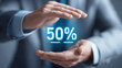 © Katerina Bond - Businessman's hands framing glowing 50% symbol, representing discount, offer, or sales promotion with a modern digital marketing concept and futuristic interface. Selective focus.