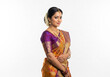 © Dani - A young woman in a vibrant South Indian silk saree poses elegantly against a white backdrop.