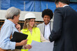 © Ladanifer - Architects and engineers examining blueprints on a construction site, discussing project details and progress