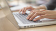 © mohammad - close-up of woman’s hands typing on clean laptop keyboard with shallow depth of field