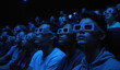 © Maryna - Group of people seated in rows watching movie in dark cinema. Person wears 3D glasses, focused on screen. Silhouettes of individuals in foreground stand out against black wall, gray floor background.