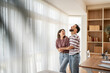© Migma_Agency - Happy couple laughing and embracing in their modern home