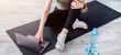 © Prostock-studio - Senior woman watching online sports course on laptop before domestic workout, indoors. Above view of mature lady taking break from exercising, resting on yoga mat with pc. Active lifestyle concept
