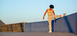 © Paula - Young African American athlete stretching leg on wall in outdoor fitness routine
