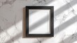 © PrettyVectors - Black wooden picture frame mockup on marble surface. Clean modern aesthetic