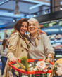 © Dragana Gordic - Joyful Shopping Experience With Grandmother and Granddaughter in Grocery Store