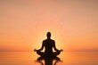 © Thitiporn - Meditative Silhouette at Sunset: A tranquil figure is seen in silhouette, meditating in a serene lotus position against the backdrop of a breathtaking sunset.