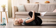 © Prostock-studio - Sporty senior woman doing exercises on yoga mat indoors, blank space. Full length of fit mature lady working out at home during covid pandemic, relaxing her back muscles