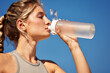 © Georgii - Woman staying hydrated while outdoors on a sunny warm day
