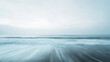 © Chookeit - A minimalist seascape with long exposure motion of ocean waves sweeping across dark sand under a pale sky, perfect for serene design, abstract expression, and wellness visuals